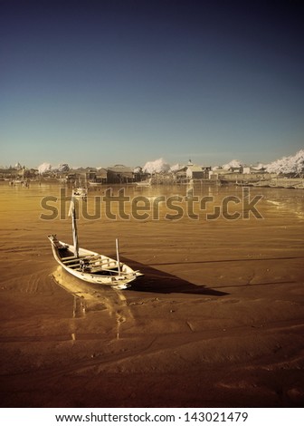 Lonely boat on receding shore