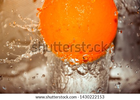 Water splash on orange fruit