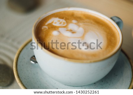 cap of coffee with spoon and picture