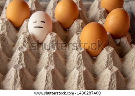 Eggs with funny faces drawn. Concept of diversity and moods. Caricatures in eggs.