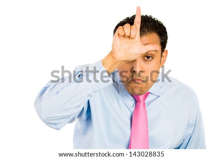 Closeup portrait of funny man displaying a loser sign on his forehead, isolated on a white background