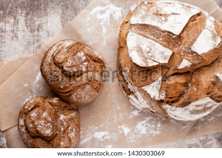 Freshly baked bread on dark gray kitchen table, top view.