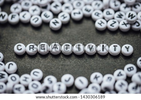 Word CREATIVITY made from small white letters on black background