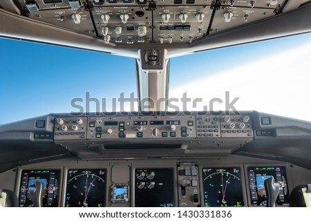 inside a big jet flying plane cockpit, autopilot turning on the right Royalty-Free Stock Photo #1430331836