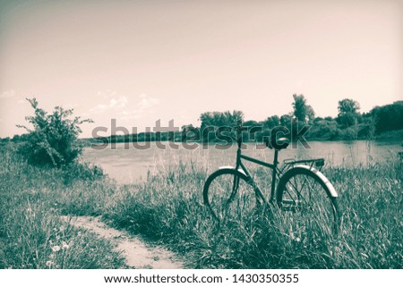 Russian nature. Summer landscape on the river, bike. Vintage photo processing