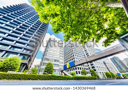 Fresh green trees and urban buildings