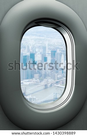 an airplane window looking out the Brooklyn Bridge and Manhattan, New York City