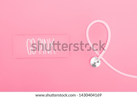 top view of stethoscope and go pink lettering on pink background