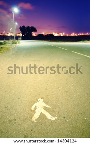 walking trail sign on pavement - night scene