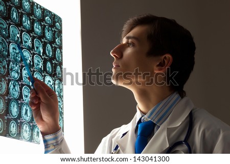 Image of male doctor pointing at x-ray results