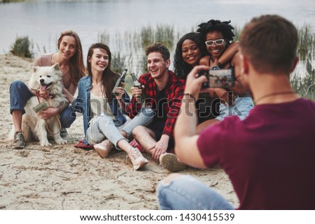 Say cheese. Group of people have picnic on the beach. Friends have fun at weekend time.