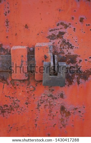 old rusty lock on the iron door
