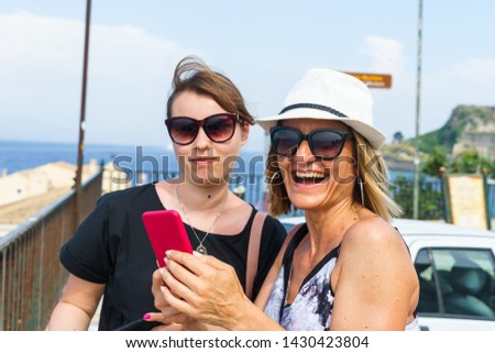 Female tourist beautiful women looking to the selfie photos on summer holiday in a sunny day