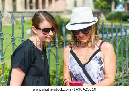 Female tourist beautiful women taking selfie photos while walking the town streets on summer holiday