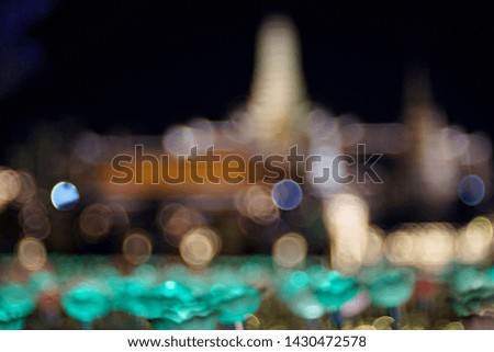 Blur of lotus like LED light field with Buddhist temple in background, Bangkok, Thailand
