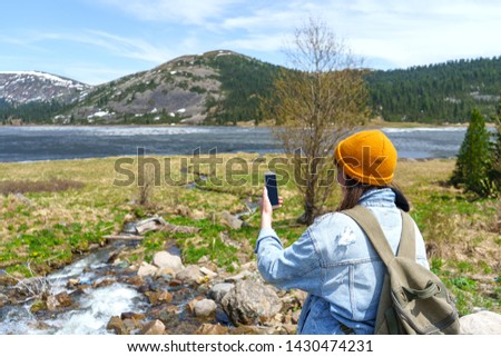 Woman using phone in mountains West Sayan