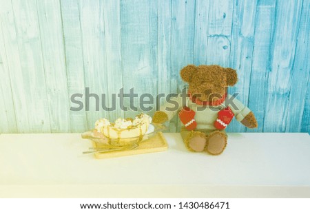 ice creams near teddy bear sit on blue background. image