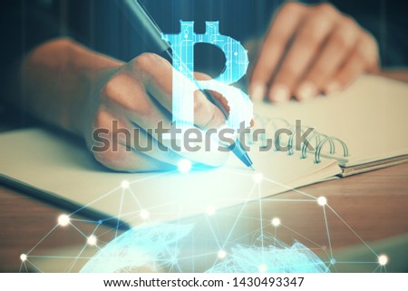 Cryptocurrency hologram over hands taking notes background. Concept of blockchain. Multi exposure