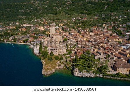 Aerial photography, on the medieval lakeside castle with a museum of history and paleontology, as well as a panoramic view from the tower. City of Malcesine on Lake Garda, Italy.