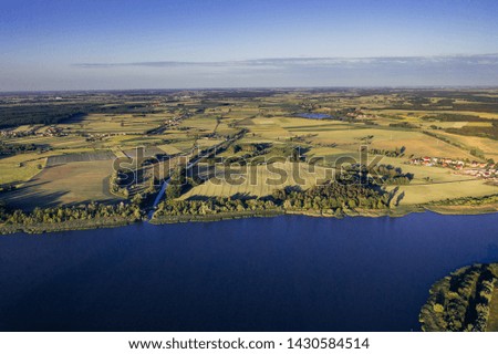 Aerial photography of lake shore and agricultural fields. 