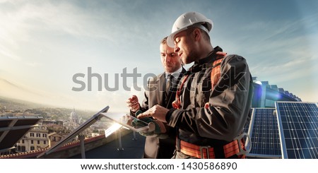 engineer and businessman planing new ecology project. around solar panel roof Royalty-Free Stock Photo #1430586890