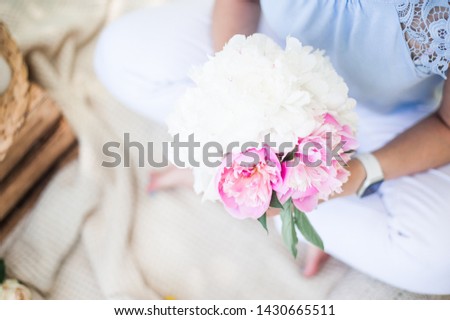 girl holding a beautiful bouquet of peonies