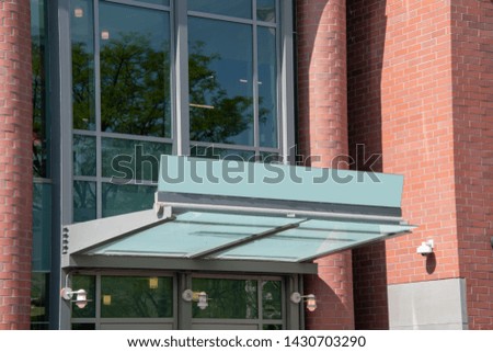 Building entrance with blank sign over the doorway