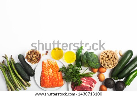 Ketogenic, keto diet, including vegetables, meat and fish, nuts and oil isolated on white background, horizontal with copy space Royalty-Free Stock Photo #1430713100