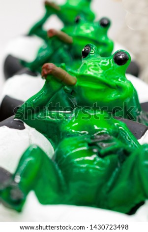 green frog made of ceramics to decorate the interior of the house or garden 