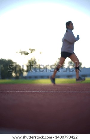 Picture blurred for background abstract ,Uniform people exercise morning at stadium in Chiang Rai Thailand.