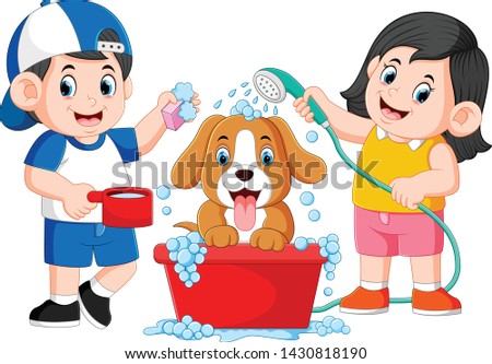 the children are clean his dog with the soap and water in the pail