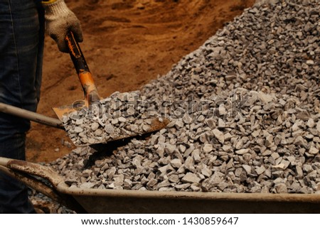 Coal mining - Man hand holding shovel and gravel black rock for background. Picture idea about coal mining, coal processing, energy source, environment protection. Industrial coals.