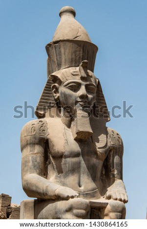 Egypt Luxor Temple. granite Statue of Ramesses II seated in front of columns Royalty-Free Stock Photo #1430864165