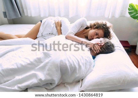 Cute Couple Lying Together In Bed At Home In Bedroom Images