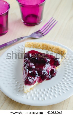 Blueberry cheese cake in white dish on the wood table