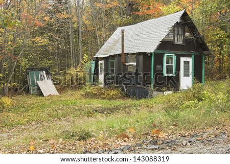 Deserted old tar paper shack in Maine. Royalty-Free Stock Photo #143088319