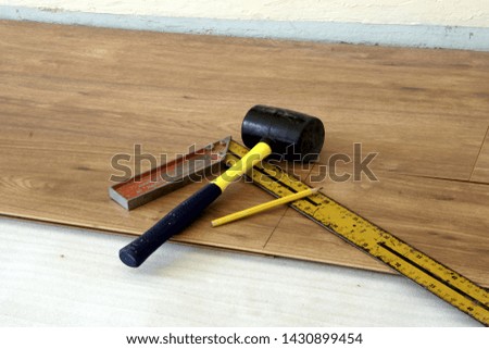 rubber hammer, pencil and ruler. tolls for mark and install laminate floor
