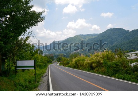 Rural Country Road on the Mountain with a sign of Doi Inthanon National Reserved Park, Thailand