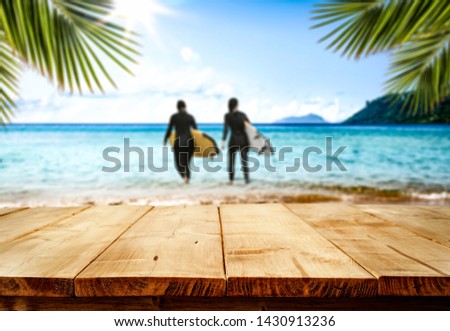 Desk of free space and summer blurred background of beach. Sunny warm day. 