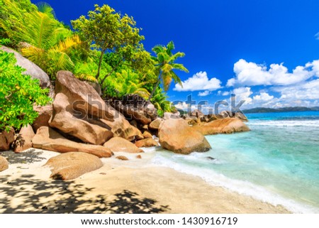 Tropical landscape of Felicite Island, Seychelles close to La Digue. Palm trees, snorkeling paradise, turquoise sea and boulder granite stone on white beach. Royalty-Free Stock Photo #1430916719
