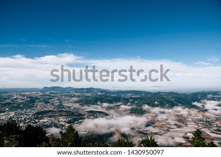 Beautiful aerial landscape shots of early morning mist covering the town bellow,  Dalat, Vietnam