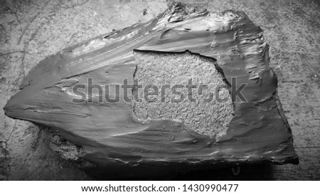 Metal part of the pump. Broken fragment of the protective disc of a slurry pump. Covered with lining resin. Horizontal frame. Picture taken in Ukraine, Kiev region. Black and white photography