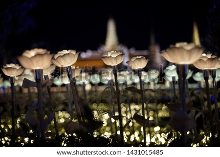 Brown lotus flower like LED light probe field with blur Buddhist temple in background, Bangkok, Thailand