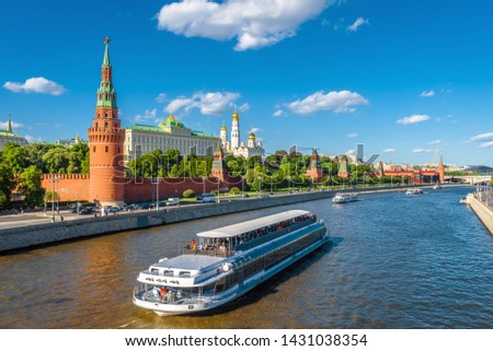 Moscow center in summer, Russia. Famous Moscow Kremlin is a top tourist attraction of city. Scenic view of the Moscow landmark and ship on Moskva River. Concept of travel and vacation in Moscow. Royalty-Free Stock Photo #1431038354