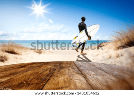 Wooden desk space for your decoration and summer background of beach. Hot summer day and sun light. Free space for your product 