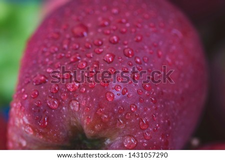 drops of water on a red apple background