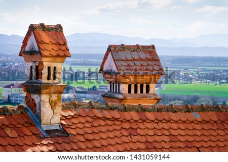 Red tile roof with chimneys in Ptuj Castle in Slovenia. Fragment of Architecture of Ptujski grad in Slovenija.