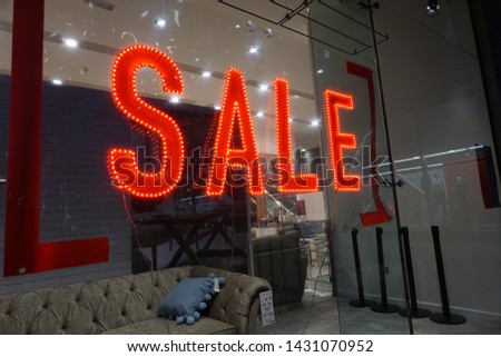 Illuminated sale sign in shop window, Wakefield UK