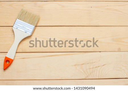 wooden background and paint brush. free text space top view