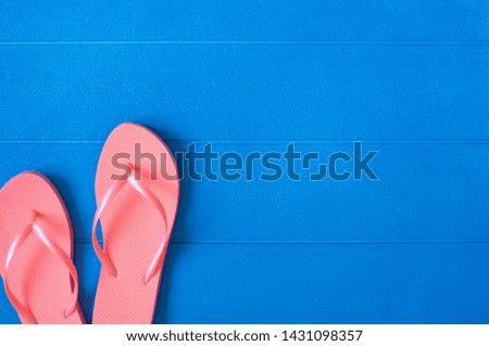 Flip flops on blue wooden background. Summer concept. Flat lay, top view, copy space